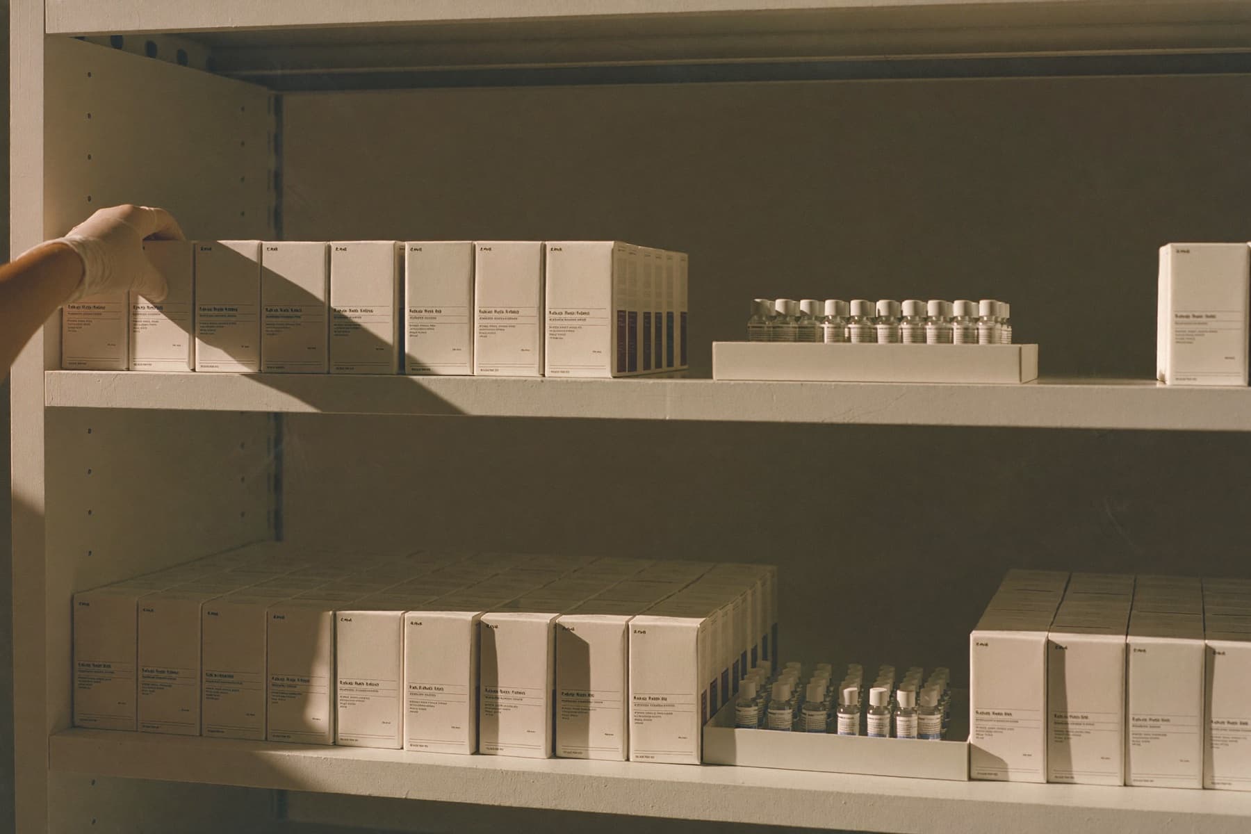 Medicine cartons and trays of vials on fulfillment shelving